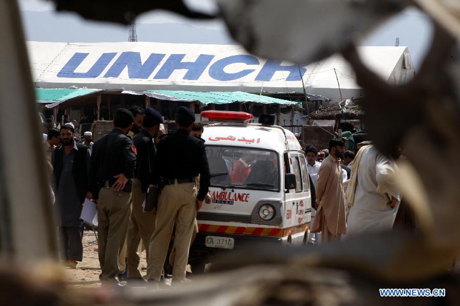 An ambulance arrives at the site of a bomb attack at the Jalozai refugee camp in northwest Pakistan's Nowshera on March 21, 2013. At least 12 people were killed and 35 others injured when a bomb hit a refugee camp in Nowshera on Thursday morning, local officials said. (Xinhua Photo/Umar Qayyum)