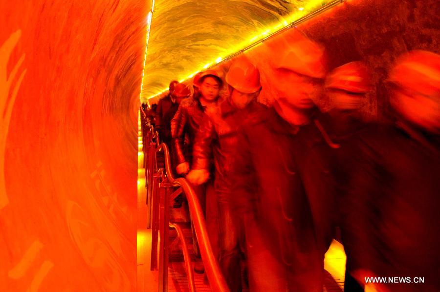 People go to watch a 4D movie at an underground cinema in the Kailuan national mine park in Tangshan, north China's Hebei Province, March 22, 2013. The 60-meter-deep cinema was reconstructed from a coal roadway which was built 130 years ago. The film showed in the cinema was about coal mining. (Xinhua/Zheng Yong)