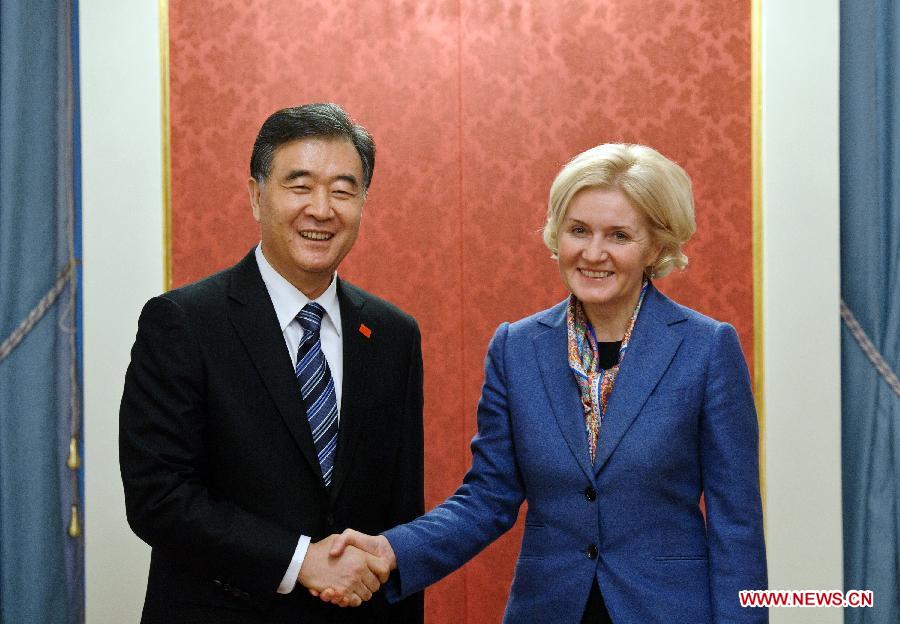 Visiting Chinese Vice Premier Wang Yang (L) shakes hands with Russian Deputy Prime Minister Olga Golodets in Moscow, Russia, March 21, 2013. Chinese Vice Premier Wang Yang, who is visiting Moscow to inspect preparations for the "Tourism Year of China" in Russia, has called for enhanced tourism cooperation between China and Russia. (Xinhua/Jiang Kehong)