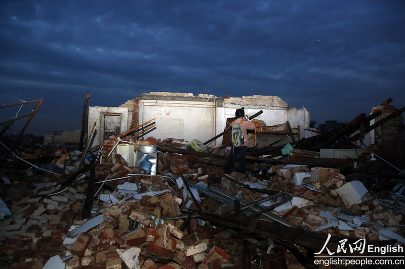 Broken wall of a shop stands among debris after a strongest thunderstorm ever recorded sweeps over Dongguan and kills nine, south China’s Guangdong province, March 20, 2013. (Photo/CFP)
