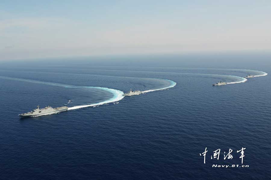 The picture shows the "Jinggangshan" amphibious dock landing ship, the "Lanzhou" guided missile destroyer, the "Yulin" guided missile frigate and the "Hengshui" guided missile frigate of the combat-readiness patrol and high-sea training taskforce under the South China Sea Fleet of the Navy of the Chinese People's Liberation Army (PLA) conducts training on the subject of battle-order deploying in the waters of the South China Sea on March 22, 2013. (PLA Daily/Qian Xiaohu Gao Yi and Gan Jun)
