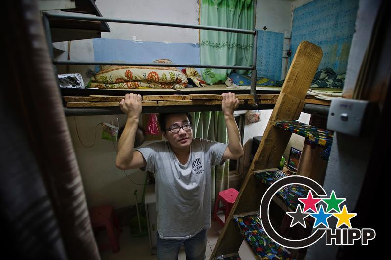 Gou Weiming of room 605 is a printing company's employee. He is 1.80 meters height. In the attic he can barely sit up straight. Standing under the attic he had to bend over.(Photo by Zhu Xiyong)