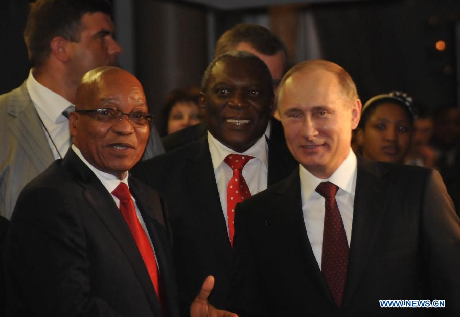 South African President Jacob Zuma(L) greets Russian President Vladimir Putin(R) upon his arrival at International Convention Centre (ICC) in Durban, southeastern port city of South Africa on March 26, 2013. South Africa will host the Fifth BRICS Summit from March 26 to 27, 2013, at the Durban International Convention Center (ICC). (Xinhua/Chang Lin)