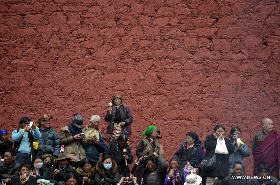 Tibetans takes part in the fire offering ceremony at the Gandan Monastery in Lhasa, capital of southwest China's Tibet Autonomous Region, March 26, 2013. The fire offering ceremony is a special ceremony in the Tibetan Tantric Buddhism. It is a sacrificial ritual of divinity worshiping in which believers burn the tributes, crops, tree branches and incantation tallies to pray for peace and harmony.
