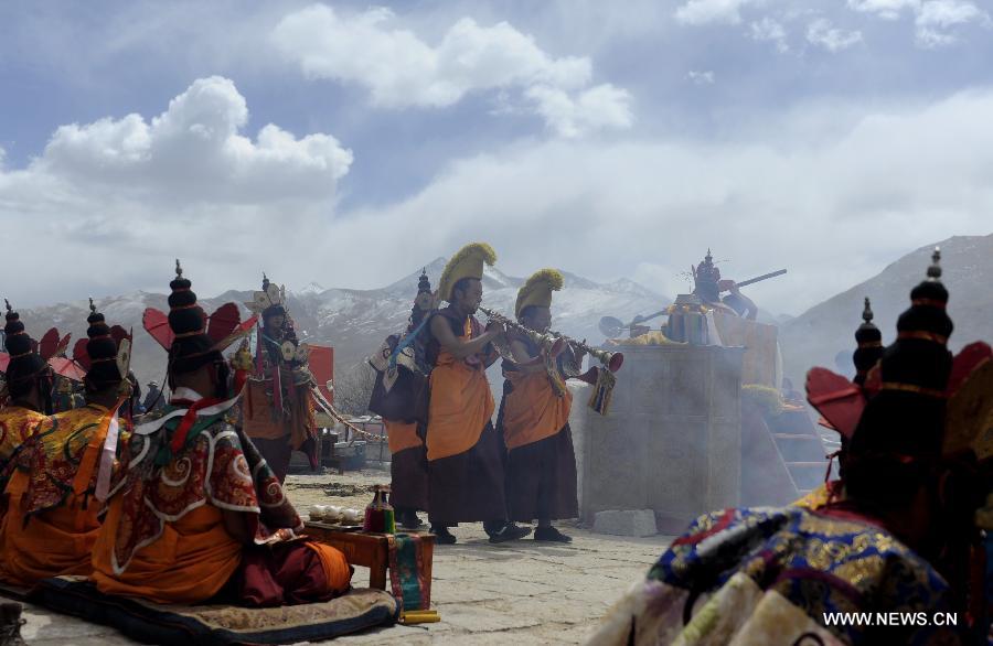 Photo taken on March 26, 2013 shows the scene of the fire offering ceremony at the Gandan Monastery in Lhasa, capital of southwest China's Tibet Autonomous Region. The fire offering ceremony is a special ceremony in the Tibetan Tantric Buddhism. It is a sacrificial ritual of divinity worshiping in which believers burn the tributes, crops, tree branches and incantation tallies to pray for peace and harmony. 