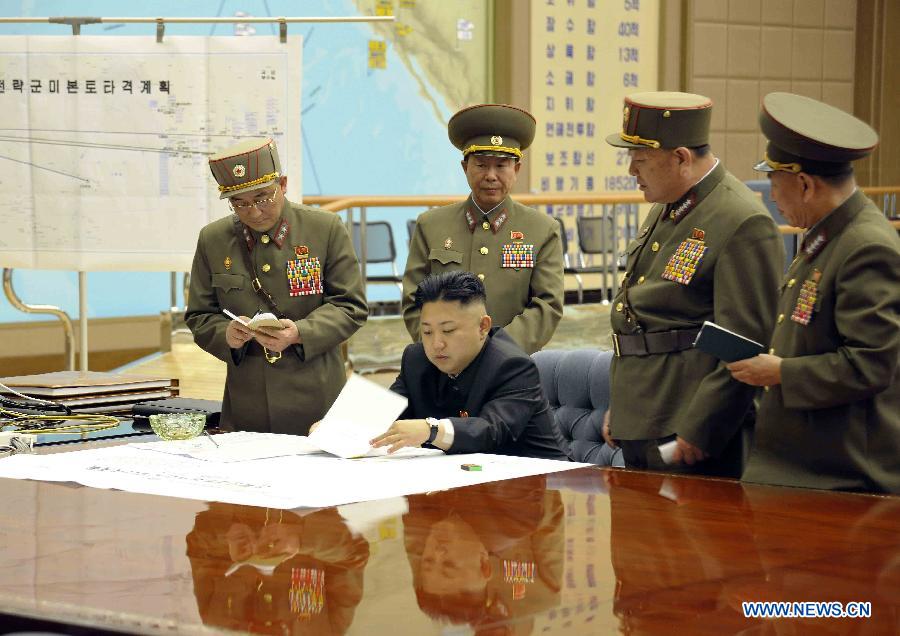 Photo released by KCNA news agency on March 29, 2013 shows top leader of the Democratic People's Republic of Korea (DPRK) Kim Jong Un (seated) attending an urgent meeting with top military officials. Kim Jong Un has ratified a strike plan by the Strategic Rocket Force as U.S. B-2 stealth bombers flew over the Korean Peninsula, the KCNA news agency reported Friday. (Xinhua/KCNA)