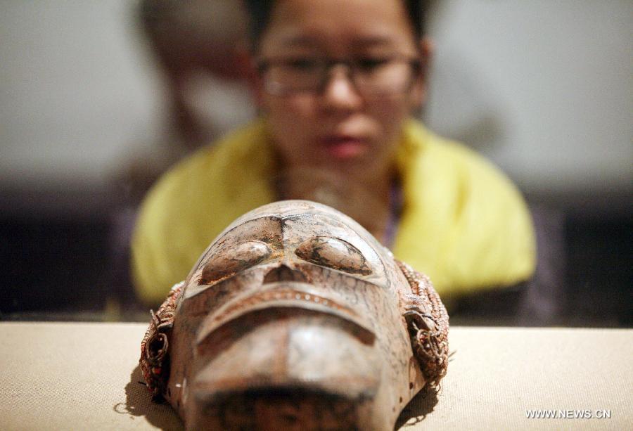 A visitor views a wood sculpture at the African Wood Sculpture Collection exhibition in Nanjing, capital of east China's Jiangsu Province, March 29, 2013. The exhibition kicking off on Friday displays nearly 600 wood carving works from dozens of countries in the sub-Saharan Africa. (Xinhua/Wang Xin) 
