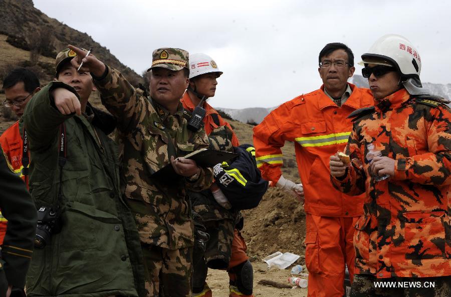 Rescuers work at the scene where a large-scale landslide hit a mining area in Maizhokunggar County of Lhasa, southwest China's Tibet Autonomous Region, March 29, 2013. Dozens of workers from a subsidiary of China National Gold Group Corporation were trapped. The exact number of trapped workers were not immediately known. (Xinhua/Chogo)