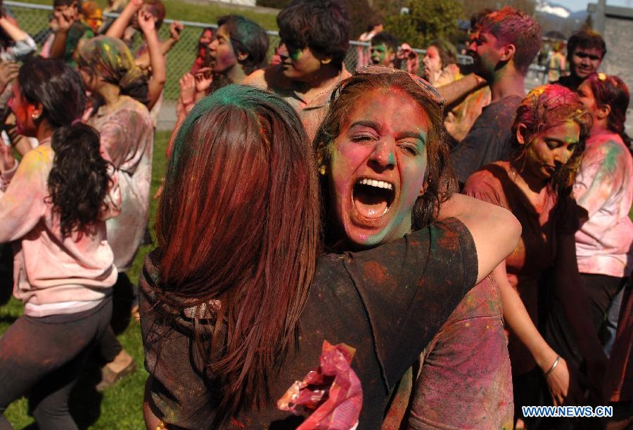Students of University of British Columbia sing and throw coloured powder on each other as they celebrate Holi, the Indian Festival of Colors, in Vancouver, Canada, on March 30, 2013. Holi is all about celebrating the colors and vitality of spring, with family and friends. (Xinhua/Sergei Bachlakov) 