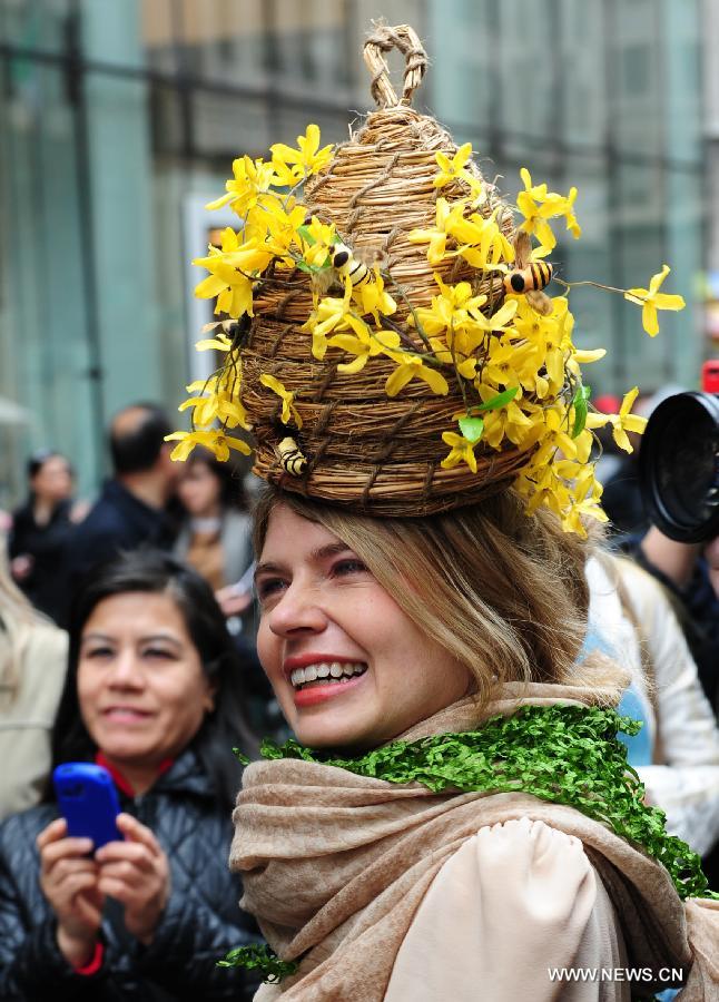 A lady with a bonnet in the shape of a hive is seen in the annual Easter Bonnet Parade in Manhattan of New York, the United States, March 31, 2013. With a history of more than 100 years, the New York Easter Bonnet Parade is held annually on the 5th Avenue near the Saint Patrick's Cathedral. Adults, children and even pets in creative colorful bonnets and outfits participate in the event, which also attract thousands of New York residents and tourists. (Xinhua/Deng Jian) 