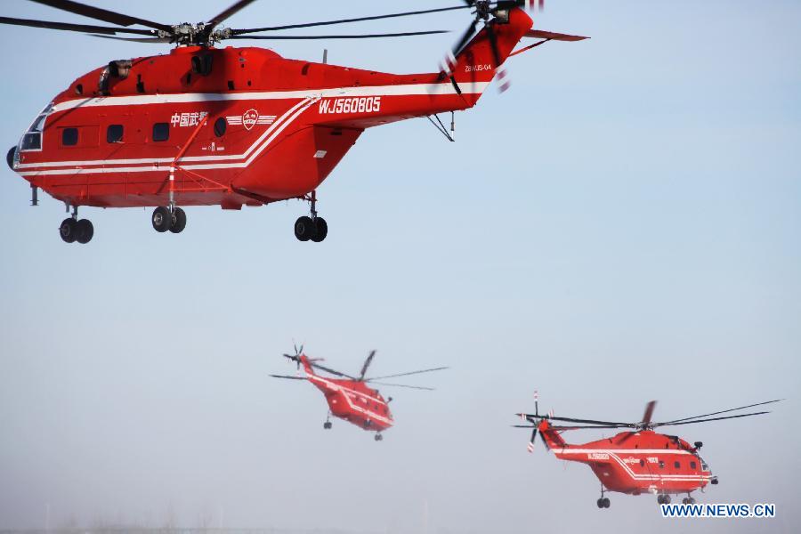 Helicopters are seen in a flight training to extinguish forest fire in Daqing City, northeast China's Heilongjiang Province, March 28, 2013. As the warm and dry spring season draws near in northern China, the risk of forest fire increases in many places. (Xinhua/Han Xinghua) 