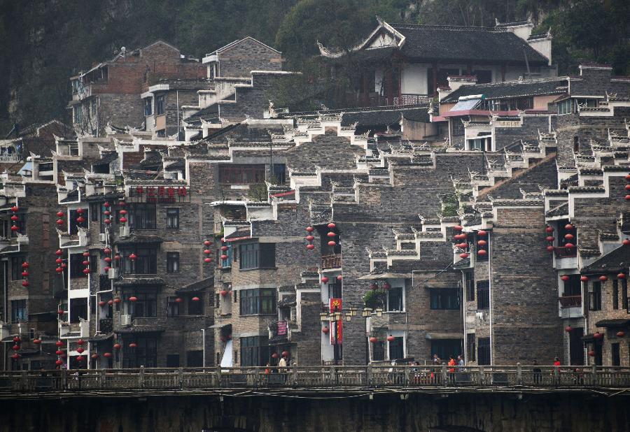 Houses are decorated by red lanterns in Zhenyuan County in southwest China's Guizhou Province, March 31, 2013. The county could date back 2,280 years with the Wuyang River running through it. As many ancient style architectures were built along the river, the ancient town was dubbed as "Oriental Venice" by tourists. (Xinhua/Hu Yan) 