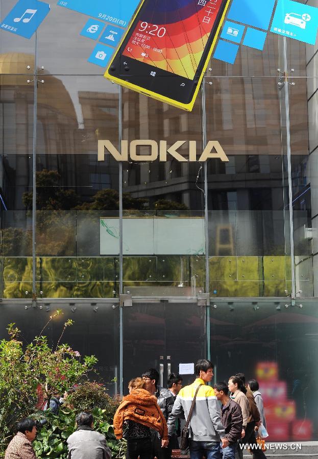 Pedestrians walk past Nokia's flagship store in Nanjing East Road in Shanghai, east China, April 3, 2013. The retail store, which is Nokia's only stand-alone flagship store and the largest around the world, was found closed in recent days. (Xinhua/Lai Xinlin)  