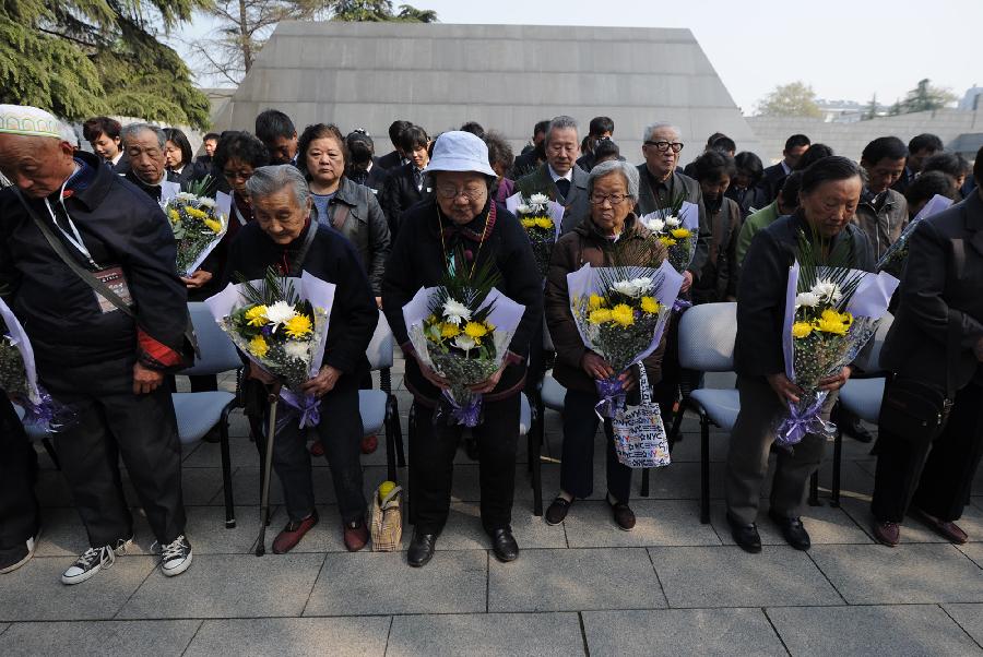 Survivors and family members of the victims of the Nanjing Massacre in 1937 attend a memorial ceremony in the Memorial Hall of the Victims in Nanjing Massacre by Japanese Invaders, in Nanjing, capital of east China's Jiangsu Province, April 4, 2013, also the Qingming Festival, or the Tomb-Sweeping Day. Lots of citizens came here to mourn Nanjing Massacre victims on Thursday. (Xinhua/Han Yuqing) 