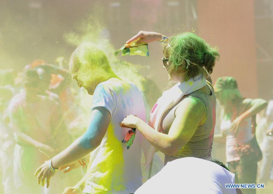 Revelers celebrate Holi, the Indian Festival of Colors, April 6, 2013. Holi is all about celebrating the colors and vitality of spring, with family and friends. (Xinhua/Li Qihua) 