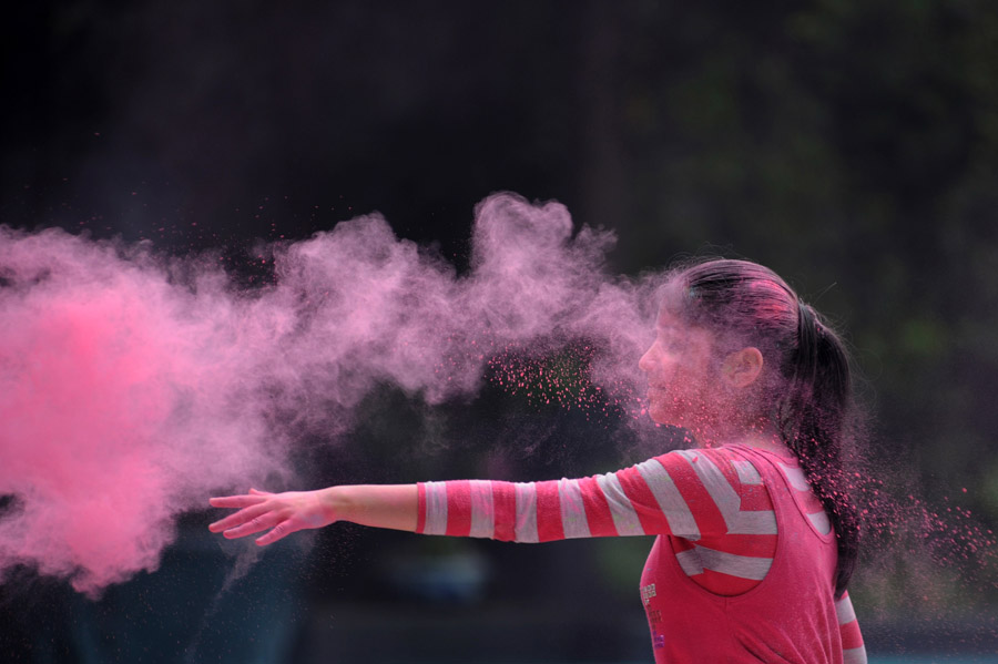 A girl scatters color powder at the Holi Festival in the Indian embassy in Jakarta, Indonesia’s capital, on April 6. (Xinhua Photo)