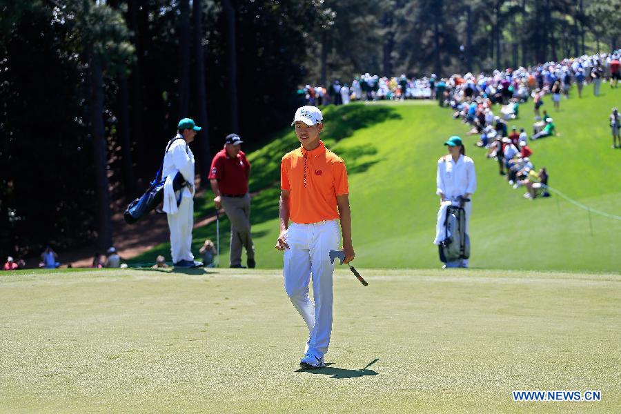 China's Guan Tianlang walks to the No. 1 green during the Par 3 Contest for the 2013 Masters at the Augusta National Golf Club in Augusta, Georgia, the United States, on April 10, 2013. (Xinhua/Chris Trotman/Augusta National)