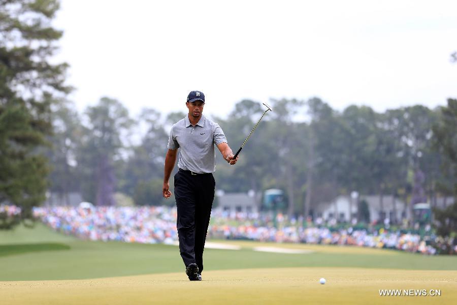 Tiger Woods of the United States reacts to a putt during the first round of the 2013 Masters golf tournament at the Augusta National Golf Club in Augusta, Georgia, the United States, April 11, 2013. Woods shot a two-under par 70 on Thursday. (Xinhua/Chris Trotman/Augusta National)