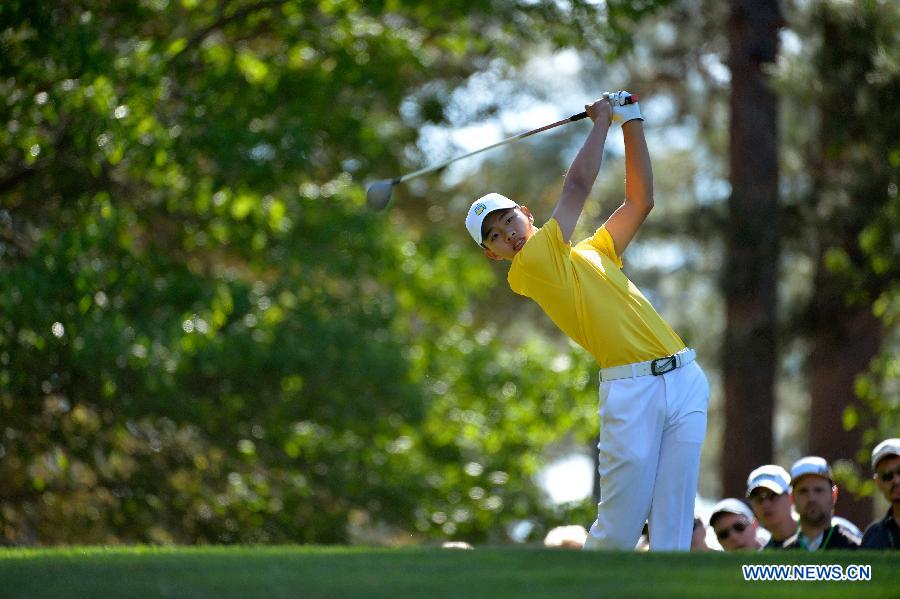 China's Guan Tianlang tees off on the fourth hole during the third round of the 2013 Masters golf tournament at the Augusta National Golf Club in Augusta, Georgia, the United States, April 13, 2013. Guan shot a five-over par 77 Saturday. (Xinhua/Charles Laberge/Augusta National)