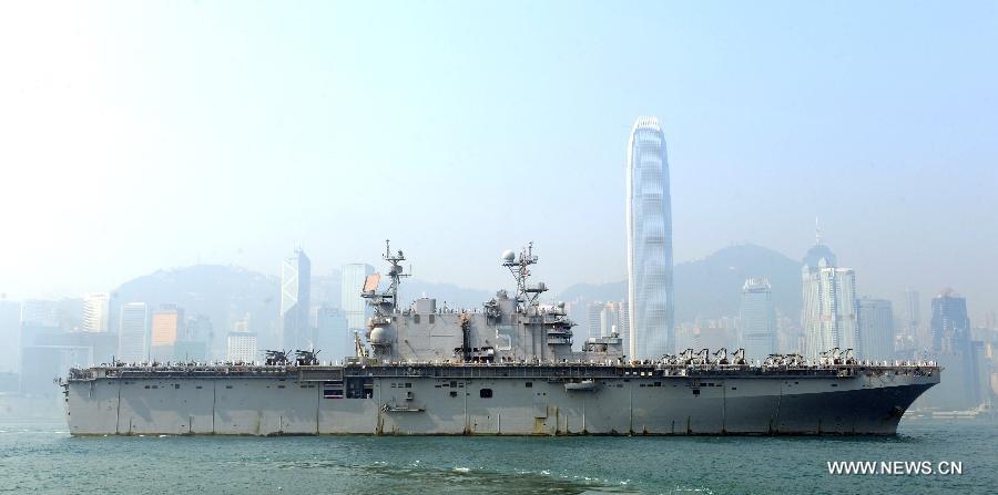 The USS Peleliu, the flagship of the U.S. navy Amphibious Squadron Three, moves into Victoria Harbor in Hong Kong, south China, April 15, 2013. Three ships of the U.S. navy Amphibious Squadron Three started to make a port visit in Hong Kong on Monday to get replenishment. USS Peleliu pulled into the Ocean Terminal besides Tsim Sha Tsui, on the northern bank of the landmark Victoria Harbor in the morning. The other two ships anchored in waters outside the Harbor. (Xinhua/Wong Pun Keung) 