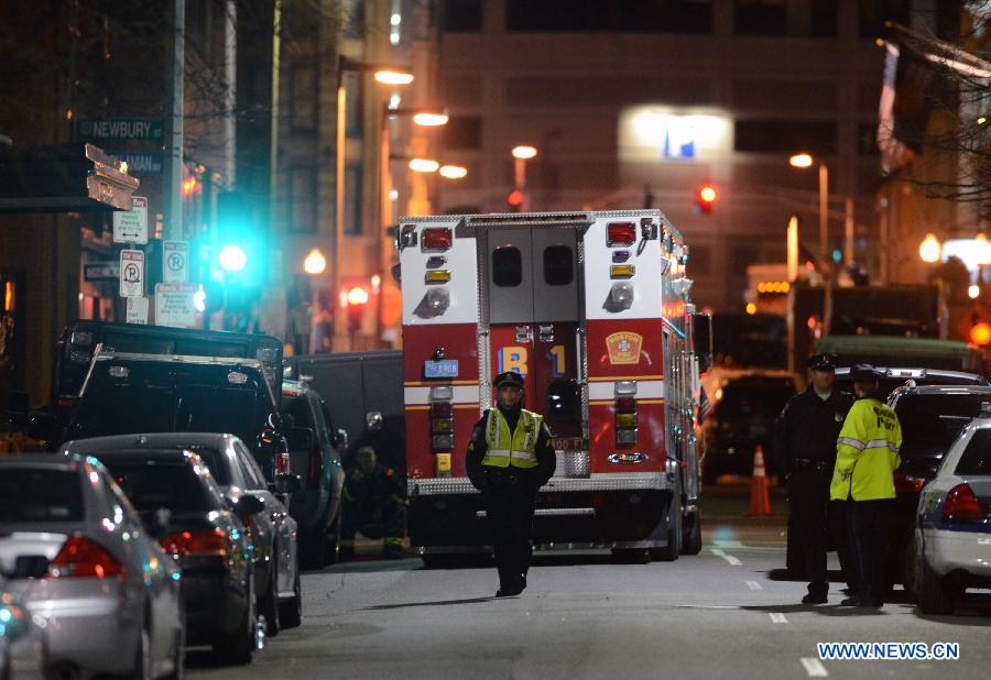 The police block off a street near the place where explosions happened in Boston, the United States, April 15, 2013. Three people were killed and 144 people wounded in the explosions according to the statistics published on April 16. (Xinhua/Wang Lei) 