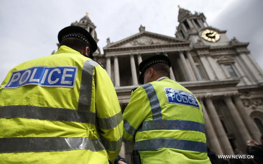 Police officers stand outside St Paul's Cathedral ahead of the funeral of former Prime Minister Margaret Thatcher in London, April 16, 2013. A ceremonial funeral service for Lady Thatcher will be held at St Paul's Cathedral in London on Wednesday. (Xinhua/Wang Lili) 
