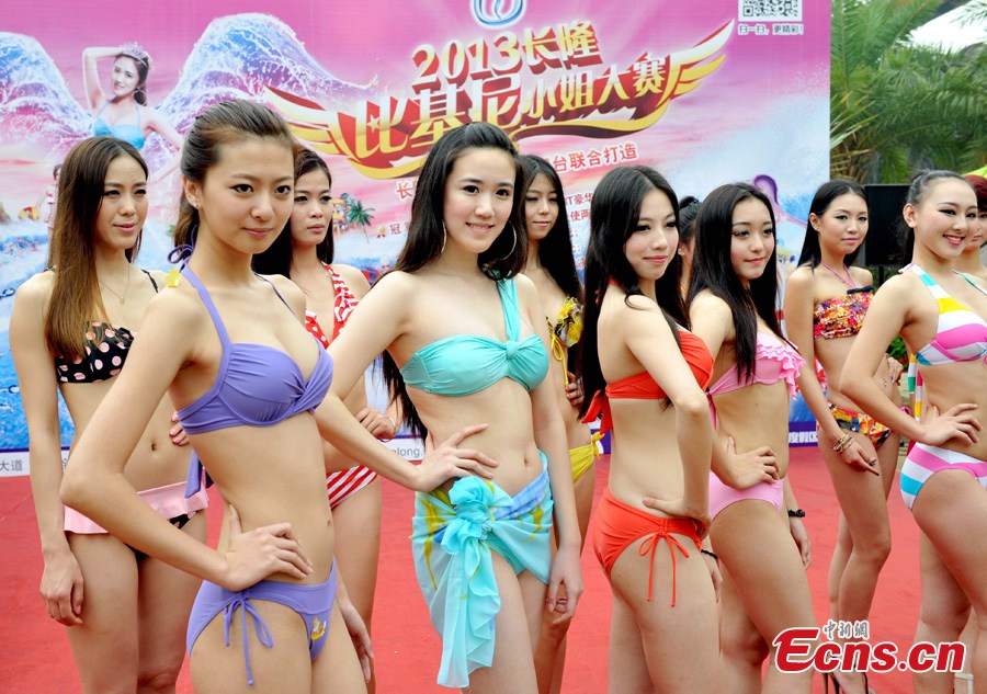 Contestants of the 5th Changlong Miss Bikini Competition pose for photos at the Water Park in Changlong, Guangzhou, the capital of South China's Guangdong Province, April 17, 2013. (CNS/Liu Weiyong)