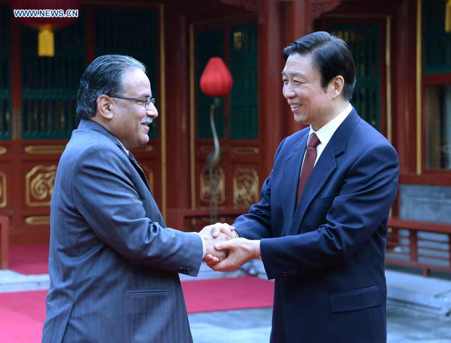 Chinese Vice President Li Yuanchao (R) shakes hands with Chairman of the Unified Communist Party of Nepal (Maoist) Prachanda ahead of their meeting in Beijing, capital of China, April 17, 2013. (Xinhua/Ma Zhancheng)