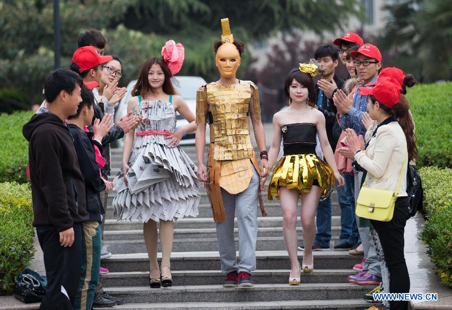 Models present creations made of waste materials during a "low-carbon fashion show" in Huaibei, east China's Anhui Province, April 18, 2013. Students of the Huaibei Normal University and employees of local power supply company were involved on the event held to call for environmental protection. (Xinhua/Wang Wen) 