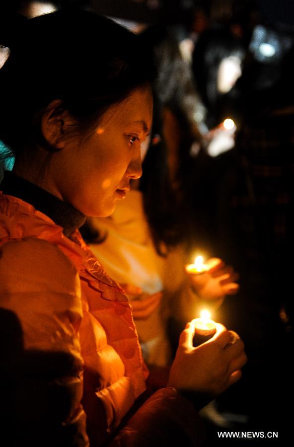 Students hold candles while attending a vigil to express their well-wishes to people in quake-hit Ya'an in southwest China's Sichuan Province at Jilin University in Changchun, capital of northeast China's Jilin Province, April 20, 2013. A total of 156 people have been killed in the 7.0-magnitude earthquake in southwest China's Sichuan Province as of 8:50 p.m. Saturday, according to the China Earthquake Administration. (Xinhua/Xu Chang)  