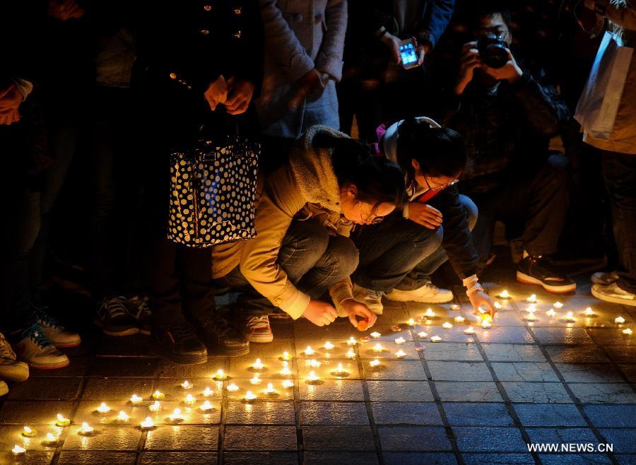 Students light candles while attending a vigil to express their well-wishes to people in quake-hit Ya'an in southwest China's Sichuan Province at Jilin University in Changchun, capital of northeast China's Jilin Province, April 20, 2013. A total of 156 people have been killed in the 7.0-magnitude earthquake in southwest China's Sichuan Province as of 8:50 p.m. Saturday, according to the China Earthquake Administration. (Xinhua/Xu Chang) 