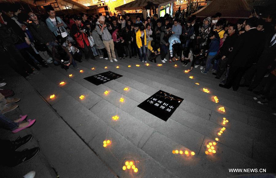 Citizens light candles at a vigil to express their well-wishes to people in quake-hit Ya'an in southwest China's Sichuan Province at Jinhua Square in Xi'an, capital of northwest China's Shaanxi Province, April 20, 2013. A total of 156 people have been killed in the 7.0-magnitude earthquake in southwest China's Sichuan Province as of 8:50 p.m. Saturday, according to the China Earthquake Administration. (Xinhua/Liu Xiao) 