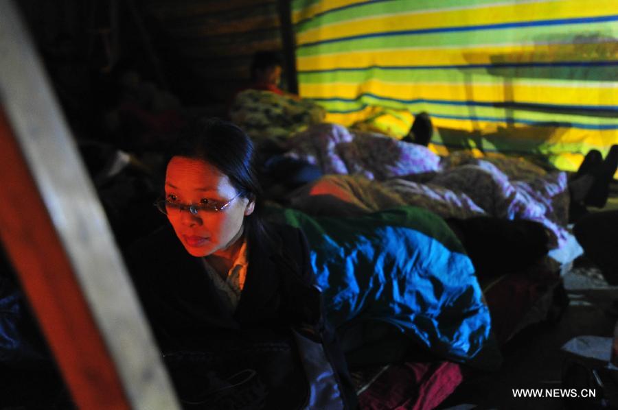 People sleep in a tent on the first night after the deadly earthquake in Lushan County, southwest China's Sichuan Province, April 21, 2013. A 7.0-magnitude earthquake jolted Lushan County of Ya'an City on April 20 morning. Many citizens chose to spend the first night after the quake on roads or in temporary tents. (Xinhua/Xiao Yijiu)  