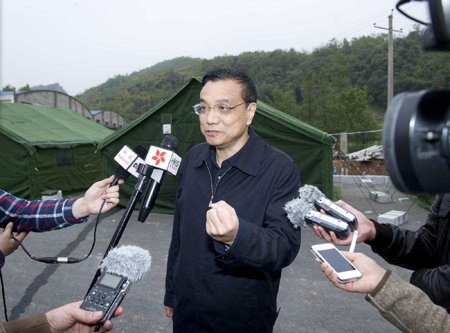 Chinese Premier Li Keqiang speaks to reporters in Lushan County of Ya'an City, southwest China's Sichuan Province, early April 21, 2013. A 7.0-magnitude earthquake jolted Lushan County Saturday morning. Premier Li Keqiang arrived in Lushan County Saturday afternoon to direct rescue work. (Xinhua/Huang Jingwen)