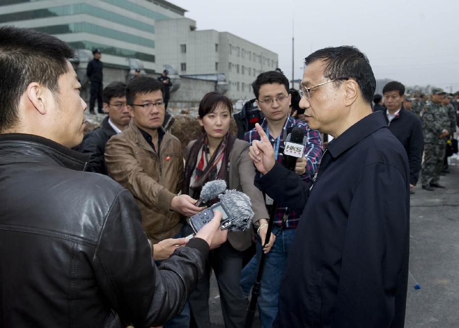 Chinese Premier Li Keqiang (R) speaks to reporters in Lushan County of Ya'an City, southwest China's Sichuan Province, early April 21, 2013. A 7.0-magnitude earthquake jolted Lushan County Saturday morning. Premier Li Keqiang arrived in Lushan County Saturday afternoon to direct rescue work. (Xinhua/Huang Jingwen)