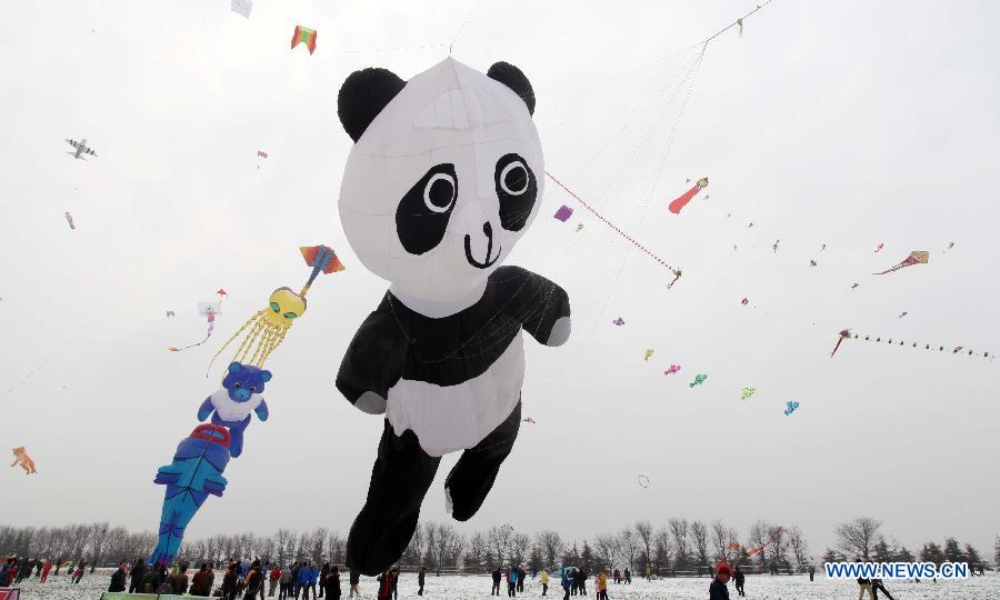 Participants fly kites at the 30th Weifang International Kite Festival in Weifang, east China's Shandong Province, April 20, 2013. Kite-making in Weifang, known as "Kite Capital," can be traced back to the late 16th century and the early 17th century. (Xinhua/Zhang Chi)
