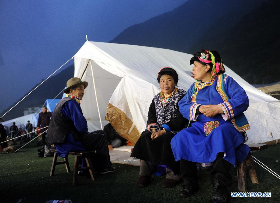 People of Tibetan ethnic group rest next to their tent in a public shelter in the quake-hit Baoxing County, southwest China's Sichuan Province, April 21, 2013. By far, a total of 28,000 people in the county have been evacuated to safety places. A 7.0-magnitude earthquake hit Sichuan at 8:02 a.m. Saturday Beijing time. (Xinhua/Luo Xiaoguang) 