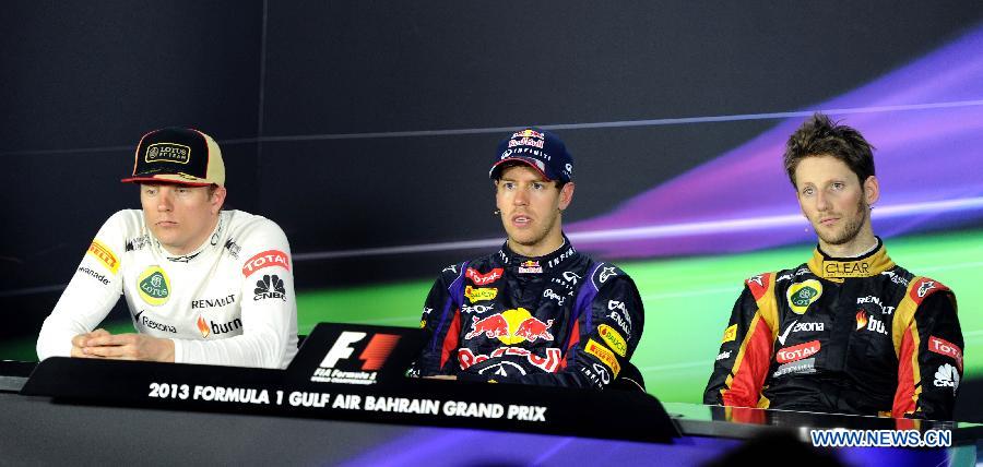 Red Bull driver Sebastian Vettel (C), Lotus driver Kimi Raikkonen (L) and Lotus driver Romain Grosjean attend a press conference after the Bahrain F1 Grand Prix at the Bahrain International Circuit in Manama, Bahrain, on April 21, 2013. (Xinhua/Chen Shaojin)
