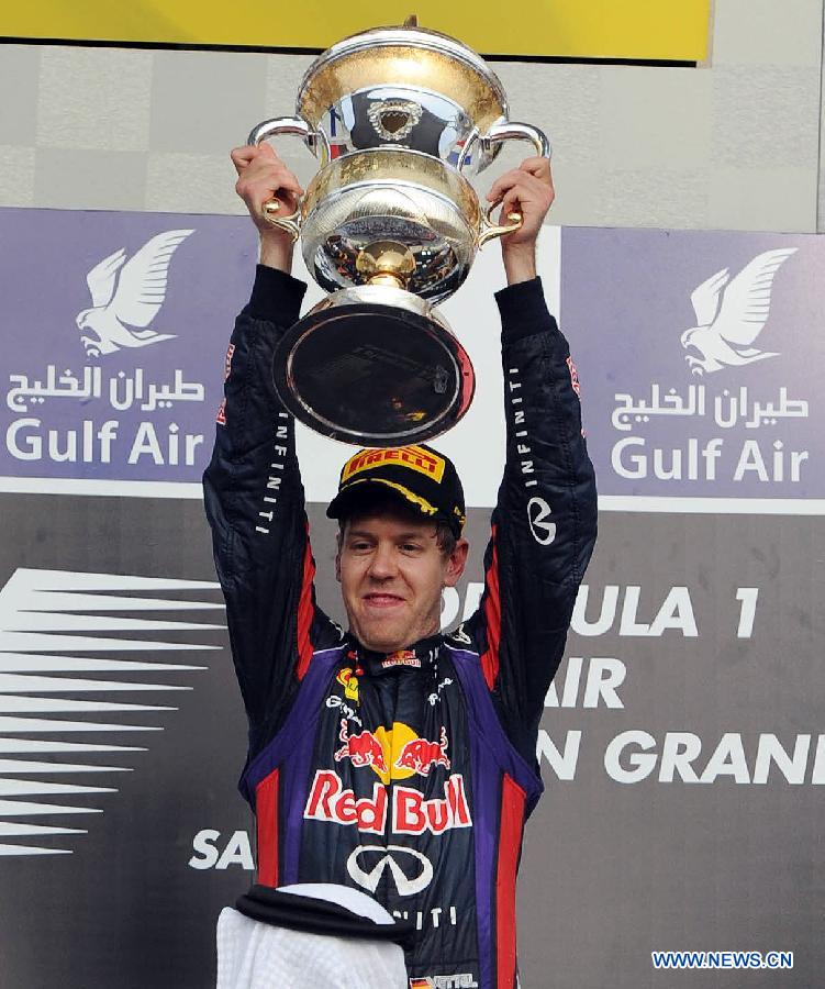 Red Bull driver Sebastian Vettel celebrates with the winner's trophy during the victory ceremony of the Bahrain F1 Grand Prix at the Bahrain International Circuit in Manama, Bahrain, on April 21, 2013. (Xinhua/Chen Shaojin)