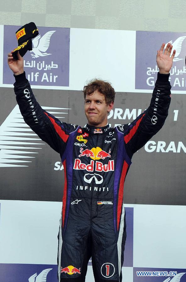Red Bull driver Sebastian Vettel celebrates during the victory ceremony of the Bahrain F1 Grand Prix at the Bahrain International Circuit in Manama, Bahrain, on April 21, 2013. (Xinhua/Chen Shaojin)