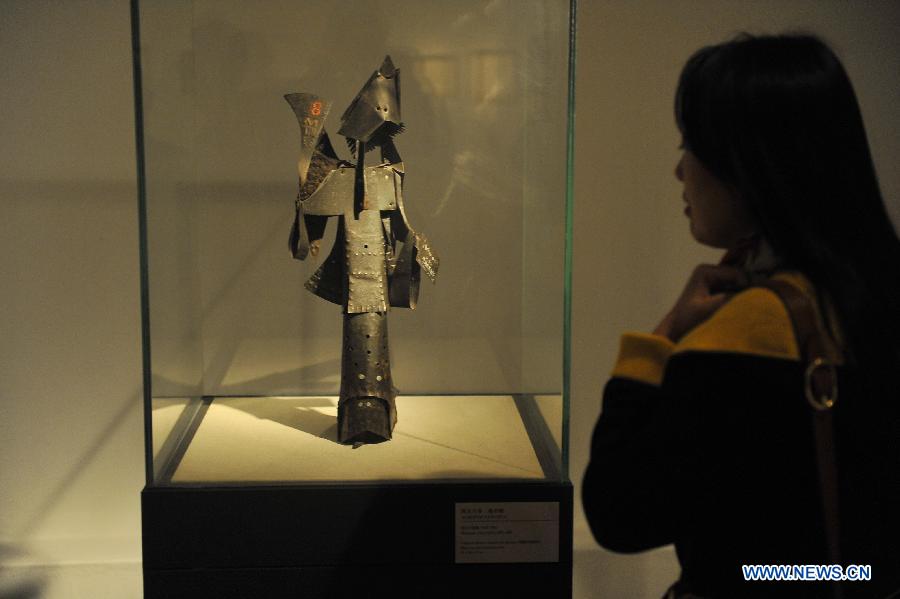 A visitor looks at an artwork in an exhibition of "From Picasso to Barcelo - Spanish Sculpture of the 20th Century" in Beijing, capital of China, April 22, 2013. A total of 79 pieces of artworks of famous Spanish artists were presented in the exhibition which celebrated the 40th anniversary of the establishment of diplomatic ties between China and Spain. (Xinhua/Lu Peng)