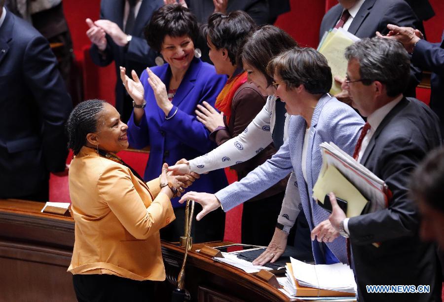 French Justice Minister Christiane Taubira (L) is greeted by left-wing legislators after the vote on same-sex marriage at the French Parliament in Paris, April 23, 2013. As the ruling Socialist Party (PS) enjoys an absolute majority at the National Assembly where 331 legislators voted for the bill and 225 voted against, it successfully paved the way for France to join dozens of other countries, mostly in Europe, to allow same-sex unions and adoption.(Xinhua/Etienne Laurent) 