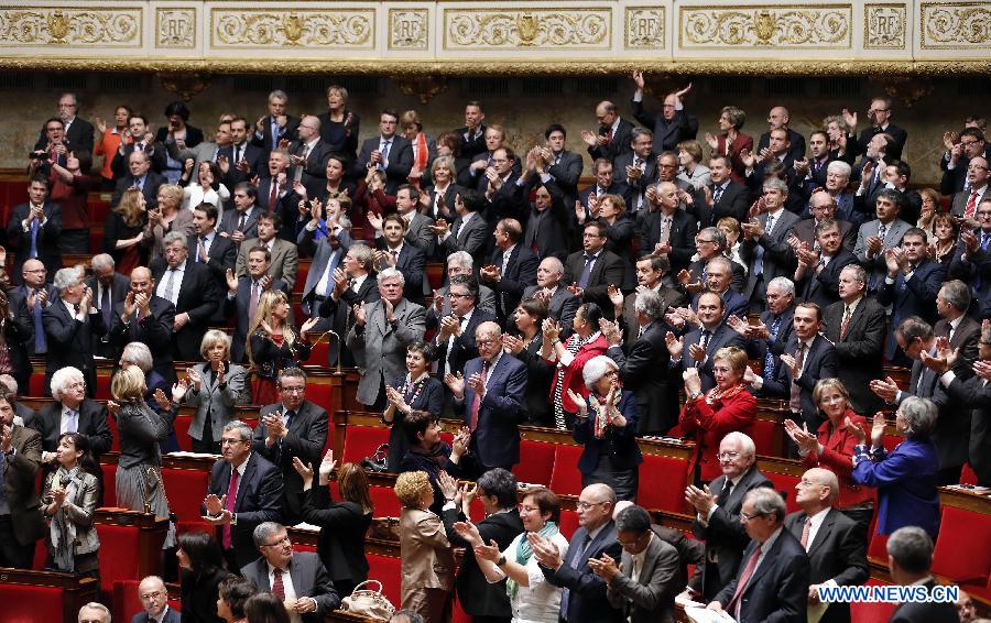 Left wing legislators stand up to welcome the passing of the vote on same-sex marriage at the French Parliament in Paris, France, April 23, 2013. As the ruling Socialist Party (PS) enjoys an absolute majority at the National Assembly where 331 legislators voted for the bill and 225 voted against, it successfully paved the way for France to join dozens of other countries, mostly in Europe, to allow same-sex unions and adoption.(Xinhua/Etienne Laurent) 