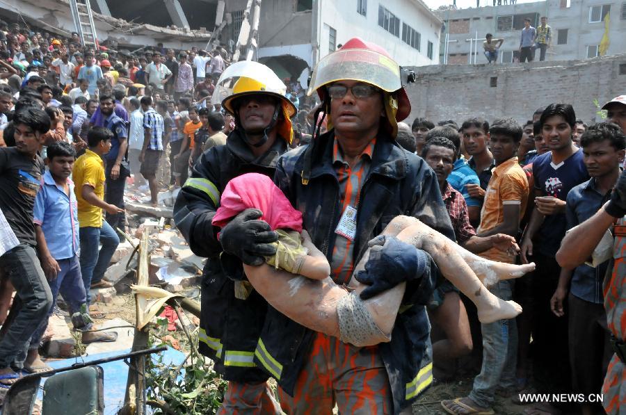 A rescuer carries an injured person after a building collapsed in Savar, Bangladesh, April 24, 2013. At least 70 people were killed and over six hundred injured after an eight-storey building in Savar on the outskirts of the Bangladeshi capital Dhaka collapsed on Wednesday morning. (Xinhua/Shariful Islam) 