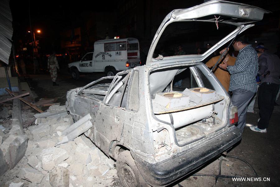 A destroyed vehicle is seen at the blast site in southern Pakistani port city of Karachi on April 25, 2013. At least five people were killed and 14 others injured in a bomb blast that hit a political gathering in Pakistan's southern port city of Karachi, local media and police said. (Xinhua/Arshad) 