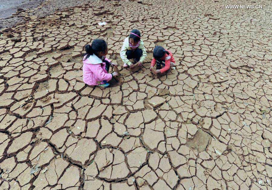 Children play at a dried-up pond in Duomaga Village of Kunming City, capital of southwest China's Yunnan Province, March 26, 2013. Over 12 million people were affected by the lingering drought in the province. (Xinhua/Yang Zongyou)