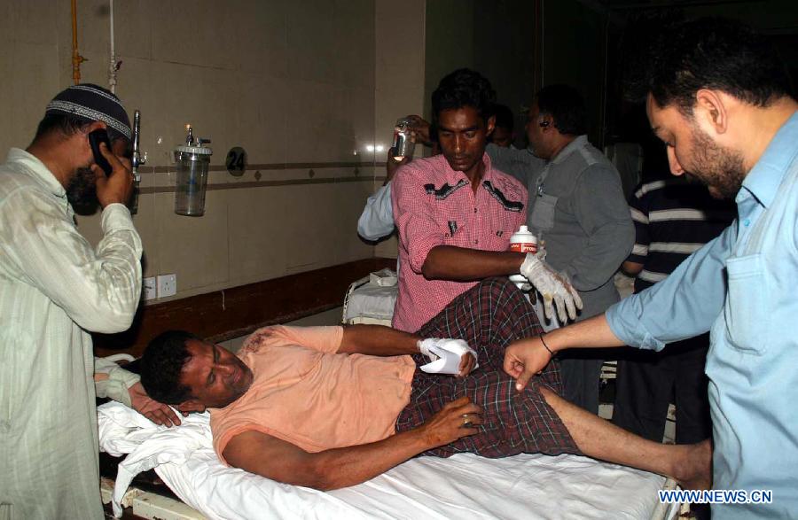 An injured man receives medical treatment at a hospital in southern Pakistani port city of Karachi on April 27, 2013. At least two people were killed and 14 others injured including three children and three women in another bomb blast on Saturday night that hit Pakistan's southern port city of Karachi, local media and police said. In another incident on Saturday night, a car bomb blast struck an office of political party Muttahida Quami Movement (MQM) or United National Movement in the Qasba Colony area of Karachi, killed two people and injuring over 20 others. (Xinhua/Arshad)