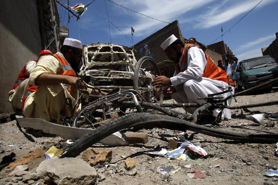 Pakistani rescuers work at the site of a bomb blast on an election candidate office in northwest Pakistan's Peshawar on April 28, 2013. At least three persons were killed and eight injured in bomb blast that occurred at the election office of an independent candidate on Sunday, local media reported. (Xinhua/Umar Qayyum)
