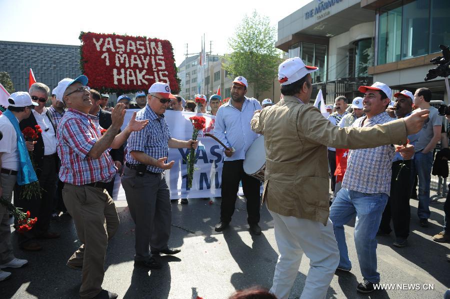 Turkish union members parade into Taksim Square to commemorate the Laber Day in Istanbul, Turkey, on May 1, 2013. Each year, Turkish union members, political parties and movements usually hold rallies at Taksim Square in Istanbul on May 1. This year, however, the government banned such rallies, citing security concerns over the ongoing construction work at the iconic square. (Xinhua/Lu Zhe) 