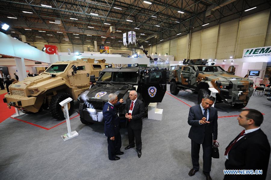 Guests visit a hall of armored vehicles made by a Turkish company in Istanbul, Turkey, May 7, 2013. The 11th International Defence Industry Fair was opened on Tuesday, with 781 companies from 82 countries and regions attending the four-day fair. (Xinhua/Lu Zhe) 